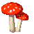 A rotating gif of two cartoon red and white toadstool mushrooms.