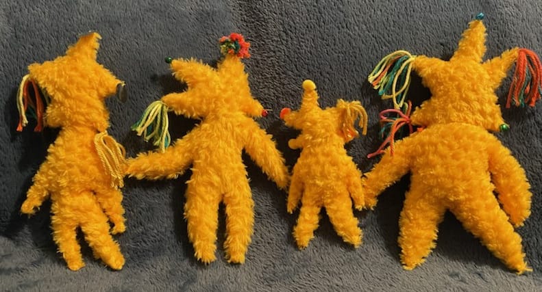 Four weezers that are yellow and fuzzy